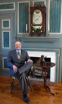 Steven sitting by fireplace